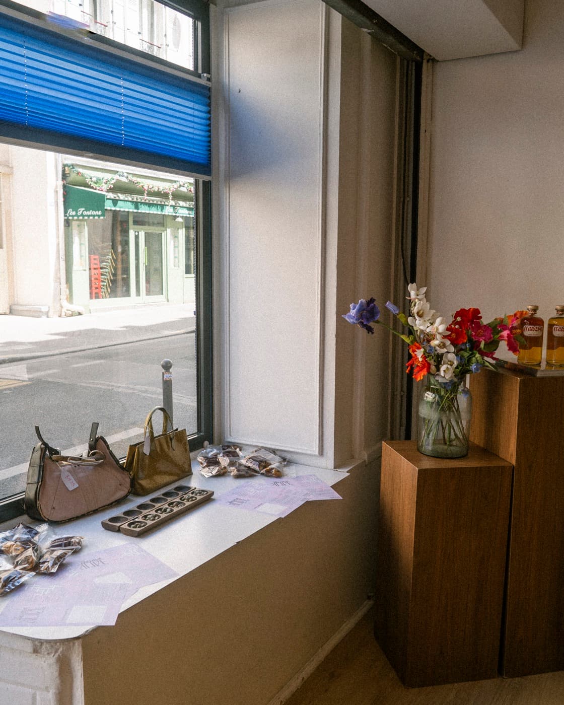 The pop-up on a Paris street — window display and passers-by.